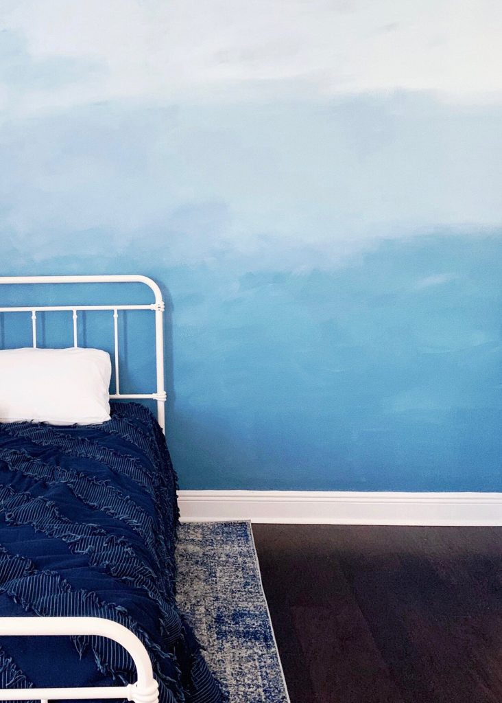 Ombre wall paint, with its gradual blending of colors from light to dark or vice versa, has emerged as a popular interior design trend that adds depth,